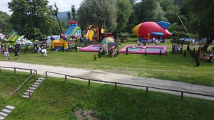 Zdjęcia zrobione podczas pikniku. Na fotografiach widać atrakcje, zjeżdżalnie, trampoliny oraz inne zabawy dla najmłodszych. Widać również uczestników pikniku.