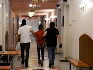 Doprowadzenie zatrzymanych mężczyzn przez policjantów do Sądu w Sanoku.